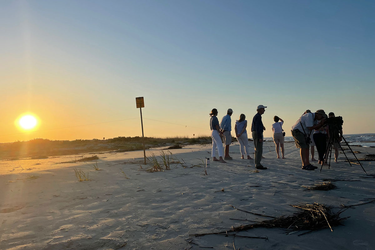 a group of people gathering at sunset